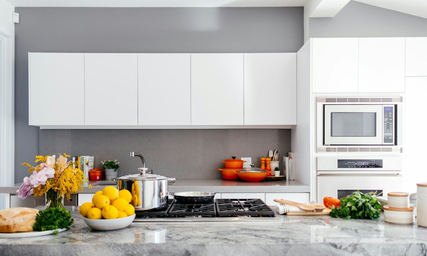 Spotless white kitchen with marble island