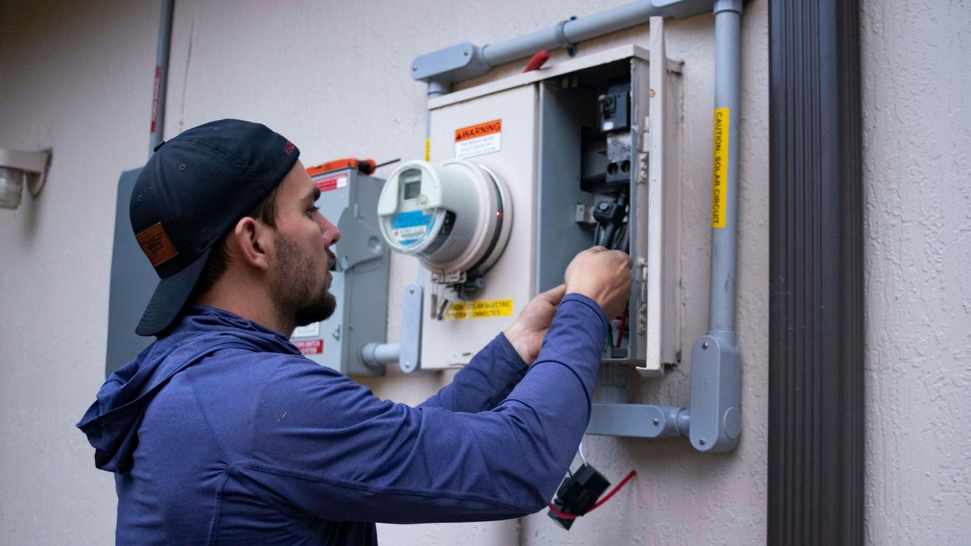 Technician working on an outdoor unit