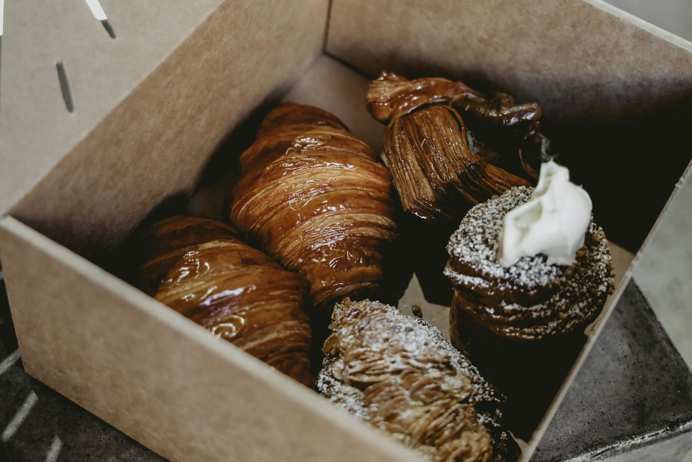 Croissants packed in a brown pastry box