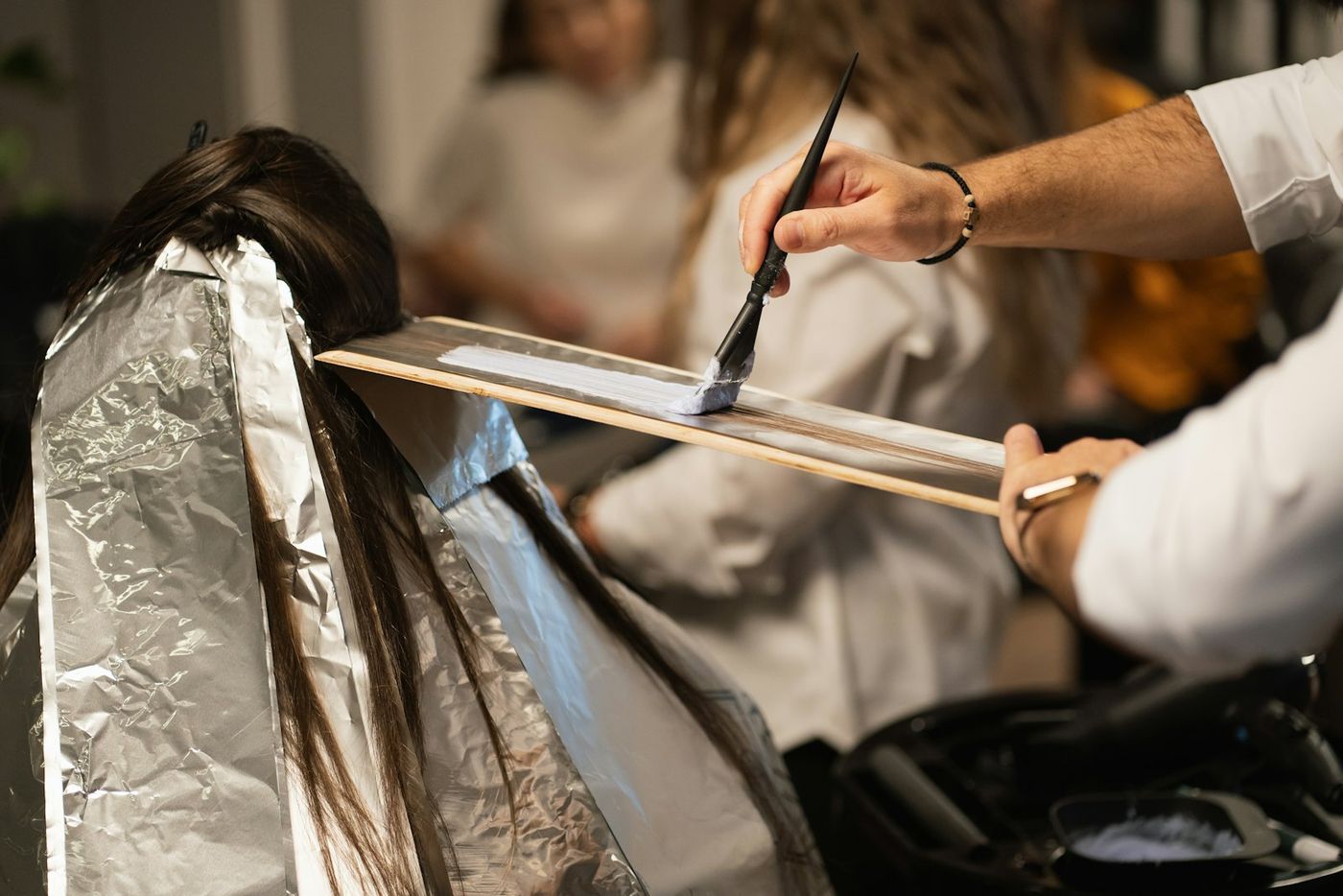 Foil highlights being painted onto hair