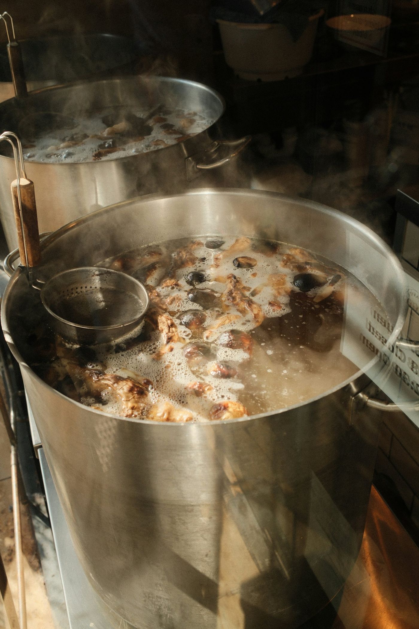 Large pots of broth simmering on the stove