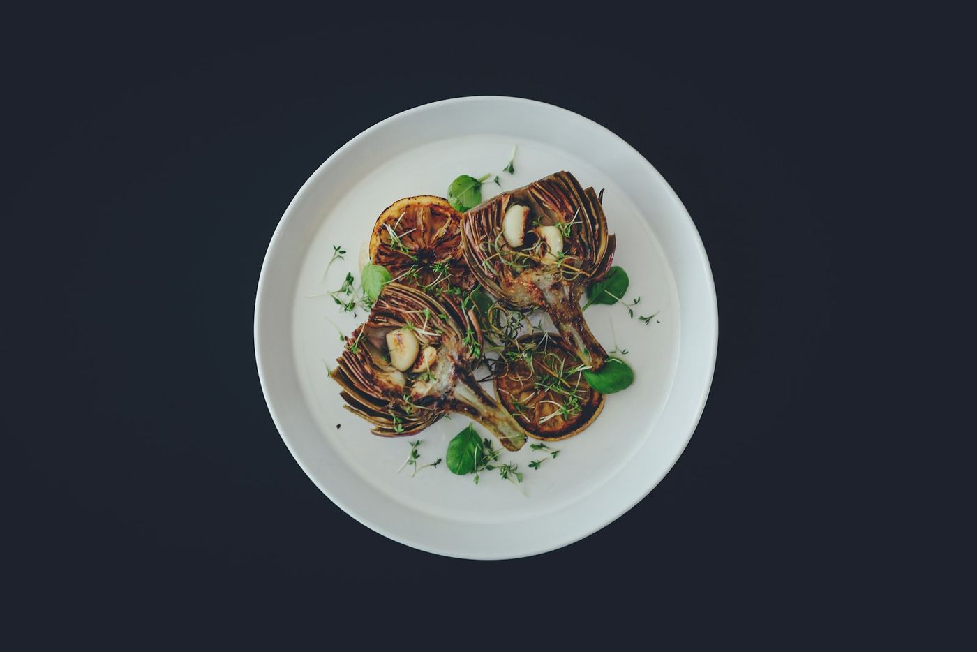 A plated dish from the wood-fired kitchen on a dark table