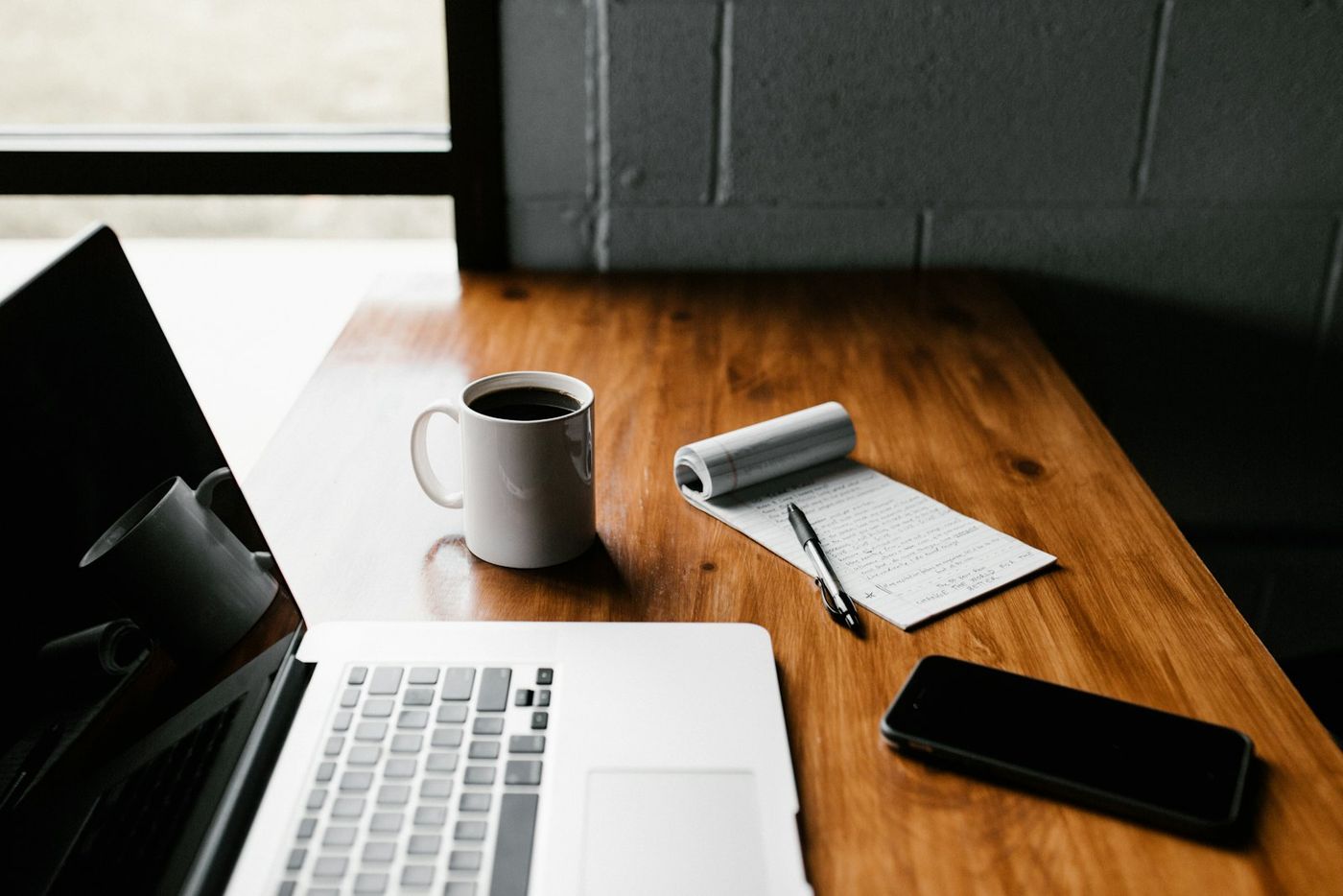 Laptop, mug and phone on a desk